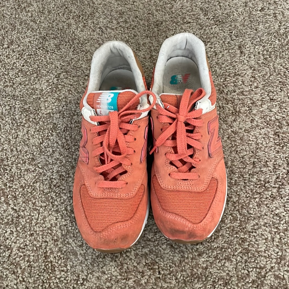 New Balance 574s in dark peach.